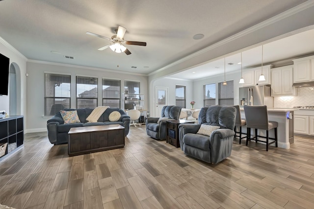 304 Welch Folly Ln, Aledo, TX 76008 - living area featuring a ceiling fan, light wood-style flooring, healthy amount of natural light, and ornamental molding