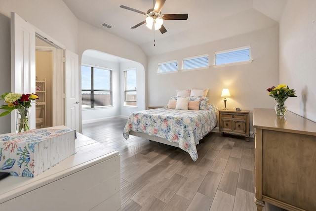 304 Welch Folly Ln, Aledo, TX 76008 - bedroom with vaulted ceiling, wood finished floors, baseboards, arched walkways, and ceiling fan