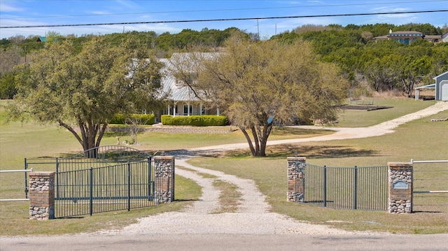 exterior space with a gate, a gated entry, and driveway