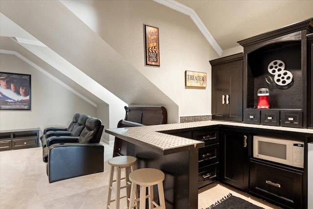 bar featuring vaulted ceiling, white microwave, light carpet, and crown molding