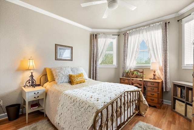bedroom featuring ornamental molding, light wood-style flooring, and baseboards