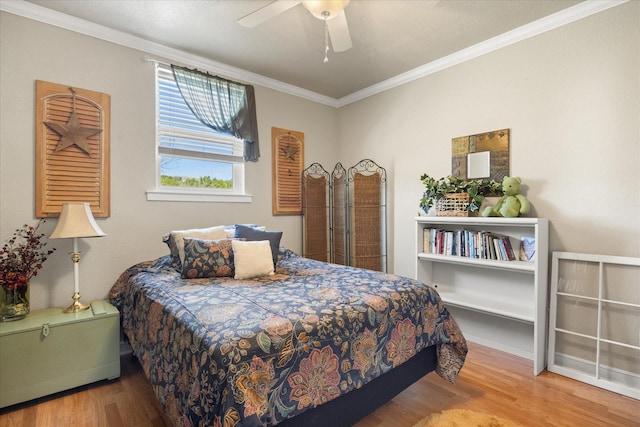 bedroom with ceiling fan, wood finished floors, and ornamental molding