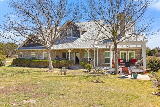 view of front of home with a front lawn, a patio, and brick siding