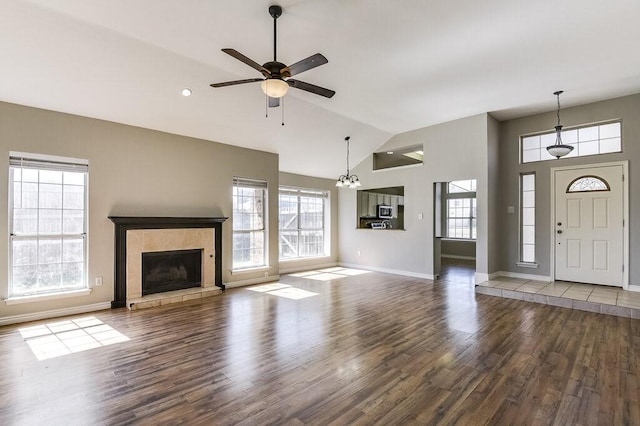 8505 Willow Creek Ct, Fort Worth, TX 76134 - unfurnished living room with wood finished floors, a ceiling fan, baseboards, a fireplace, and high vaulted ceiling