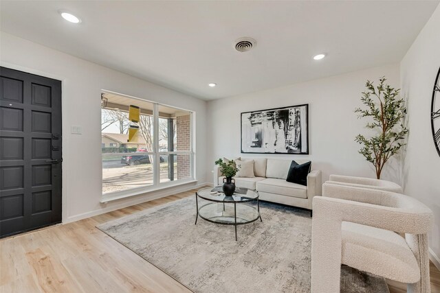 2809 Maple Dr, Garland, TX 75042 - living room with wood finished floors, baseboards, and recessed lighting