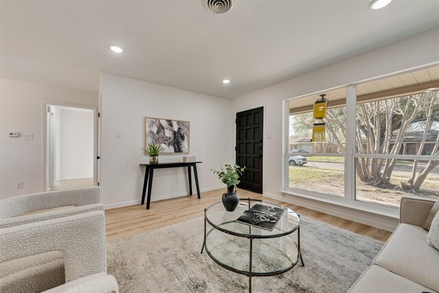 2809 Maple Dr, Garland, TX 75042 - living area featuring healthy amount of natural light, recessed lighting, wood finished floors, and baseboards