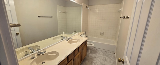 full bathroom featuring tile patterned floors, toilet, double vanity, and a sink