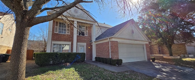 traditional-style house with brick siding, driveway, and an attached garage
