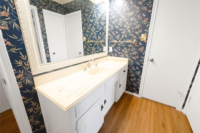 4379 Capra Way, Benbrook, TX 76126 - bathroom featuring wallpapered walls, wood finished floors, vanity, and baseboards