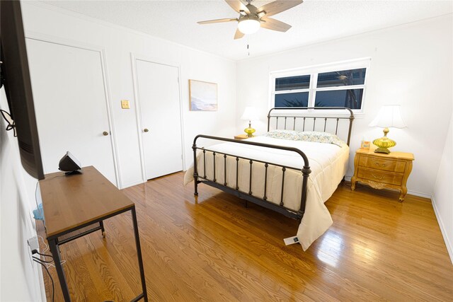 4379 Capra Way, Benbrook, TX 76126 - bedroom with light wood-style flooring, crown molding, baseboards, and a ceiling fan