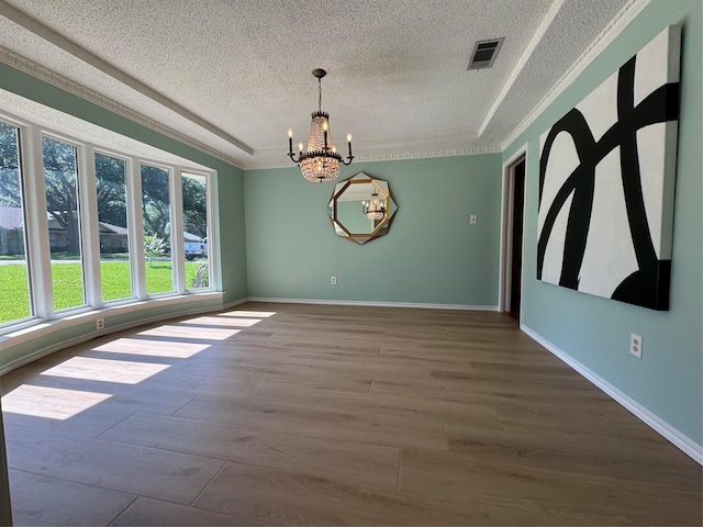 4379 Capra Way, Benbrook, TX 76126 - unfurnished room featuring a textured ceiling, a chandelier, wood finished floors, baseboards, and ornamental molding