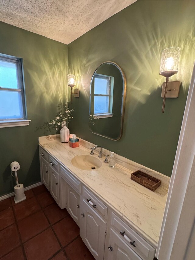 4379 Capra Way, Benbrook, TX 76126 - bathroom featuring vanity, a textured ceiling, plenty of natural light, and tile patterned floors