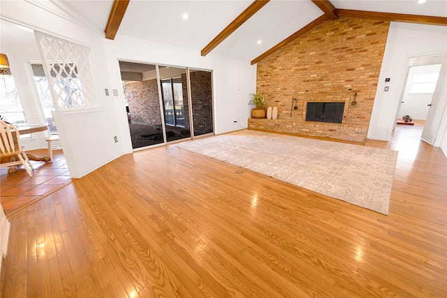 4379 Capra Way, Benbrook, TX 76126 - unfurnished living room with wood finished floors, healthy amount of natural light, a brick fireplace, and baseboards