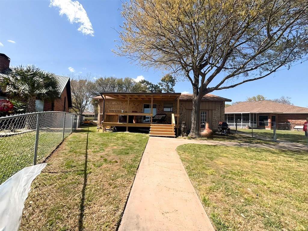 167 Seaside, Gun Barrel City, TX 75156 - view of front facade with brick siding, a front lawn, fence, and a deck