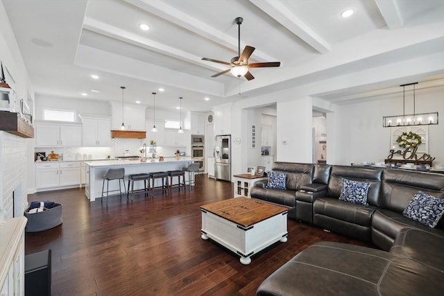1208 S Pecan Pkwy, Northlake, TX 76247 - living area featuring beamed ceiling, a fireplace, dark wood-style flooring, and ceiling fan with notable chandelier