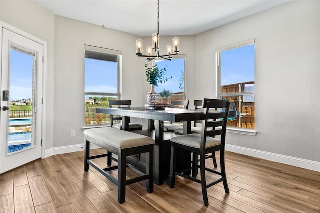 1261 Duke Dr, Prosper, TX 75078 - dining space featuring baseboards, a chandelier, and wood finished floors