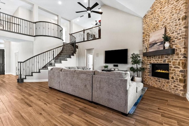 1261 Duke Dr, Prosper, TX 75078 - living area with high vaulted ceiling, ceiling fan, wood finished floors, and stairs