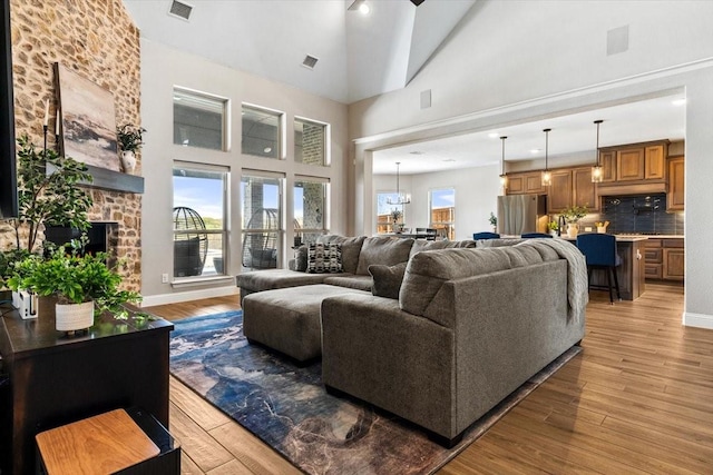 1261 Duke Dr, Prosper, TX 75078 - living room featuring high vaulted ceiling, visible vents, and light wood-type flooring