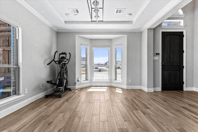 1261 Duke Dr, Prosper, TX 75078 - foyer featuring a tray ceiling, wood finished floors, baseboards, and crown molding