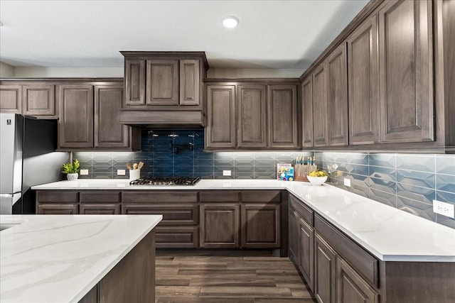 1261 Duke Dr, Prosper, TX 75078 - kitchen featuring appliances with stainless steel finishes, dark wood-type flooring, backsplash, light stone counters, and recessed lighting