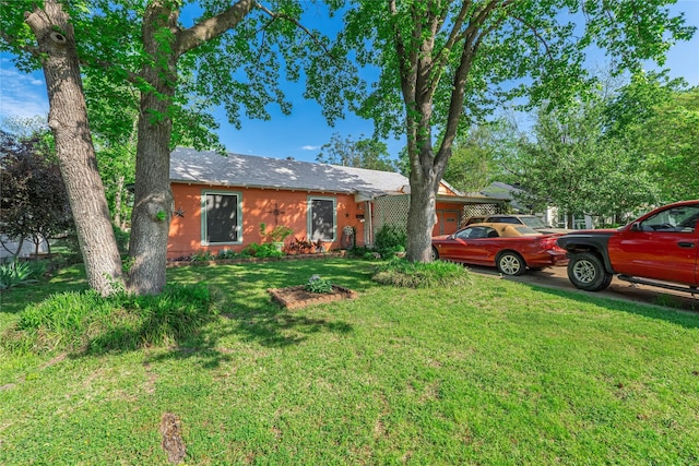 exterior space featuring a garage and a front yard