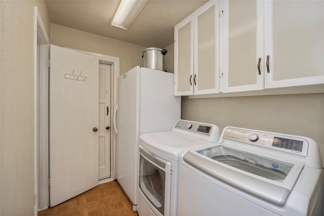 laundry area with cabinet space and washing machine and dryer