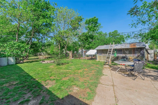 view of yard featuring exterior structure, an outdoor structure, and fence