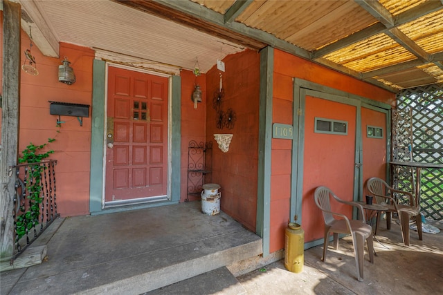 view of exterior entry with covered porch