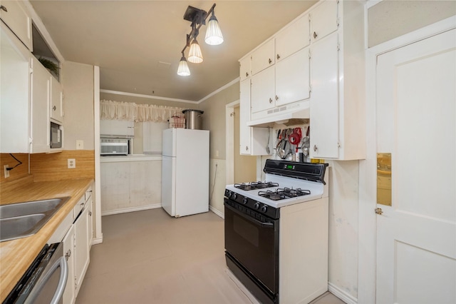 kitchen with freestanding refrigerator, white cabinetry, gas stove, light countertops, and under cabinet range hood