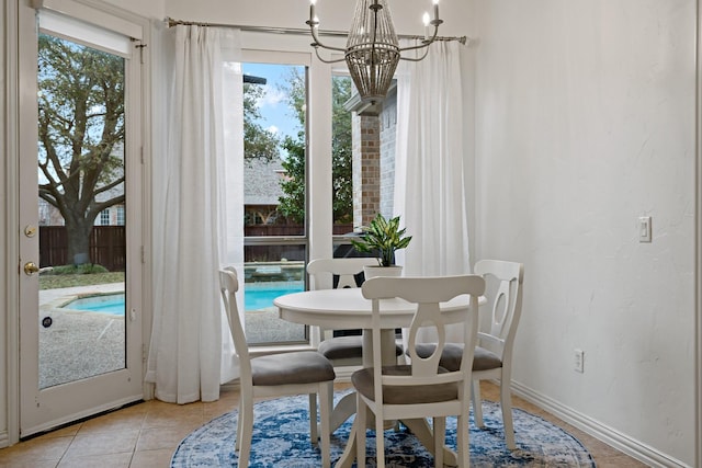 6004 Blossom Ct, Mckinney, TX 75072 - dining area with a chandelier, baseboards, and light tile patterned floors