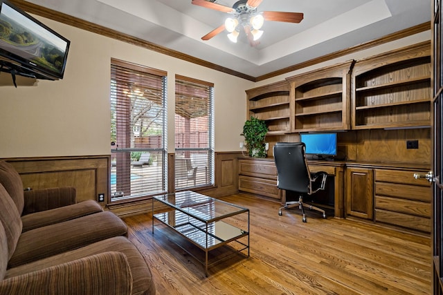 6004 Blossom Ct, Mckinney, TX 75072 - office space featuring built in desk, ceiling fan, wainscoting, a raised ceiling, and light wood-type flooring
