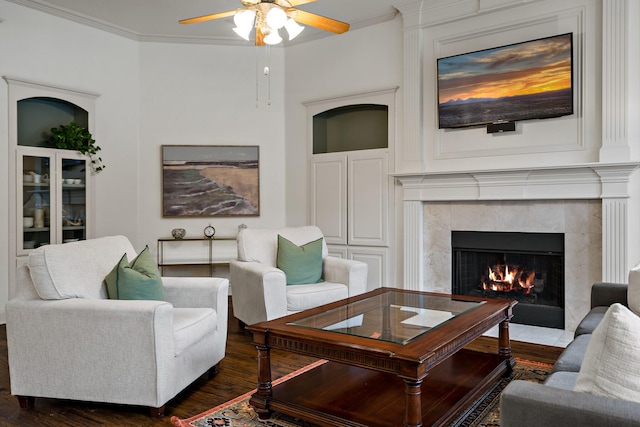 6004 Blossom Ct, Mckinney, TX 75072 - living room featuring a fireplace, dark wood-style flooring, a ceiling fan, and ornamental molding