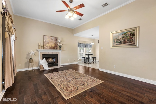 living room with wood-type flooring, a fireplace, ceiling fan, and visible vents