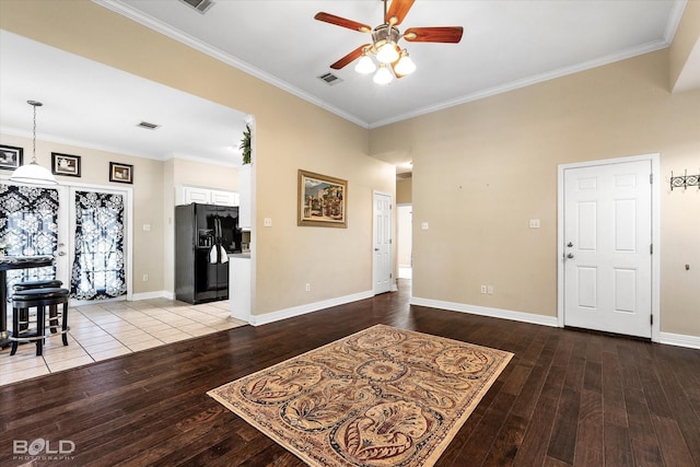foyer featuring visible vents, ceiling fan, ornamental molding, and hardwood / wood-style floors