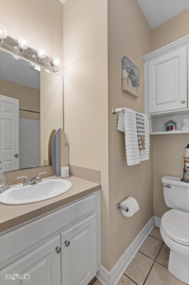 bathroom with tile patterned floors, vanity, toilet, and baseboards