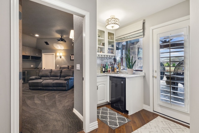 15961 Custer Trl, Frisco, TX 75035 - bar featuring wet bar, baseboards, refrigerator, and dark wood-style floors