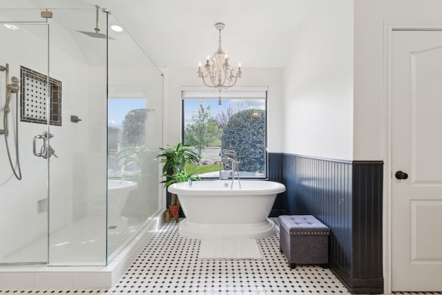 15961 Custer Trl, Frisco, TX 75035 - bathroom with a stall shower, a chandelier, a freestanding tub, and a wainscoted wall