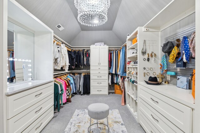 15961 Custer Trl, Frisco, TX 75035 - walk in closet featuring light carpet, a chandelier, and vaulted ceiling