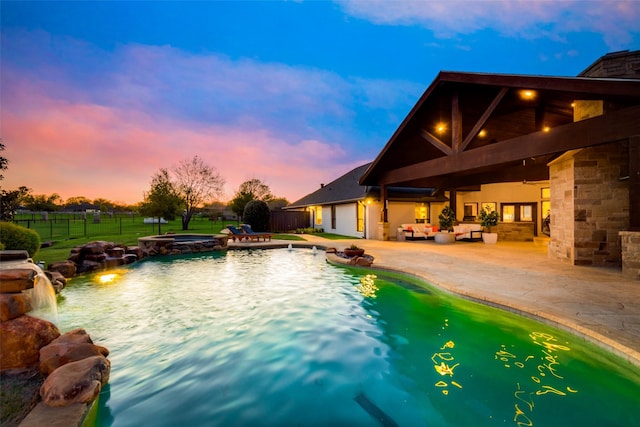 15961 Custer Trl, Frisco, TX 75035 - pool at dusk with a patio area, an outdoor living space, and a pool with connected hot tub