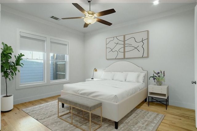613 E Wall St, Grapevine, TX 76051 - bedroom featuring crown molding, light wood-type flooring, baseboards, visible vents, and a ceiling fan