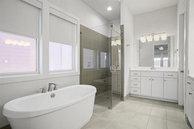 613 E Wall St, Grapevine, TX 76051 - bathroom with a soaking tub, tile patterned flooring, vanity, and a stall shower