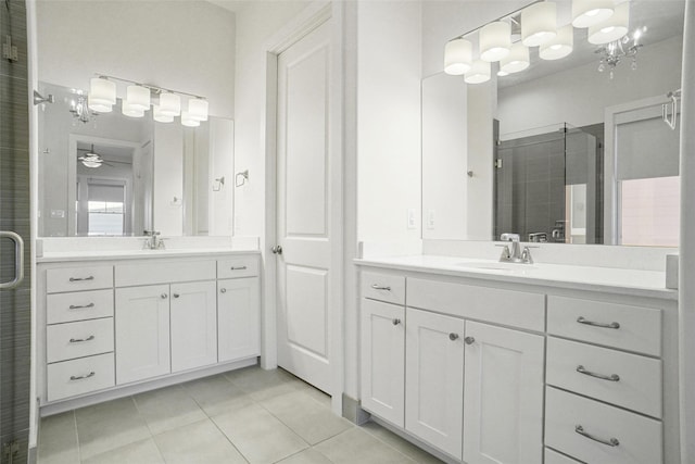 613 E Wall St, Grapevine, TX 76051 - bathroom with a sink, tile patterned flooring, a shower stall, and two vanities