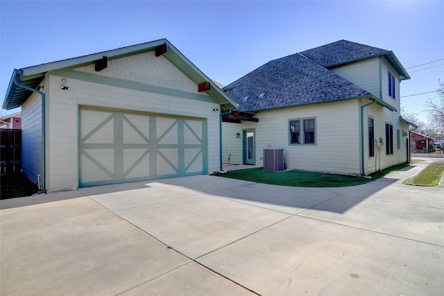 613 E Wall St, Grapevine, TX 76051 - view of front of home featuring central air condition unit, concrete driveway, roof with shingles, and an attached garage