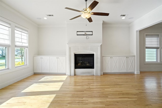 613 E Wall St, Grapevine, TX 76051 - unfurnished living room featuring wood finished floors, a ceiling fan, a glass covered fireplace, crown molding, and recessed lighting