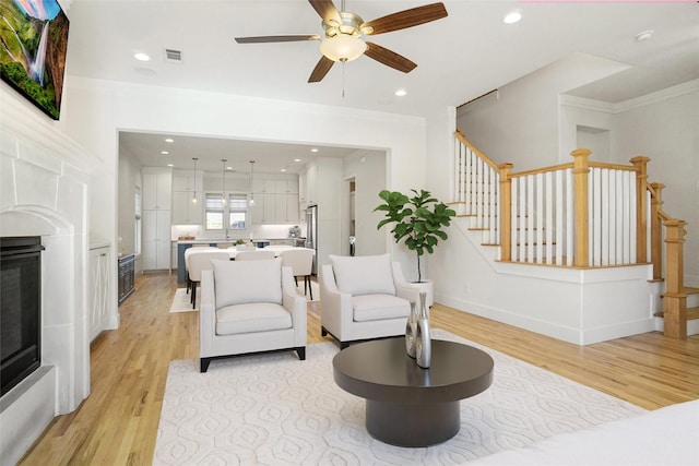 613 E Wall St, Grapevine, TX 76051 - living area with light wood-style flooring, stairway, ceiling fan, and visible vents