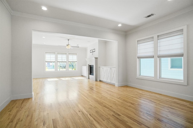 613 E Wall St, Grapevine, TX 76051 - unfurnished living room featuring visible vents, light wood-style floors, and ornamental molding