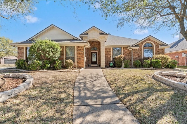 view of front of property with a front lawn and brick siding