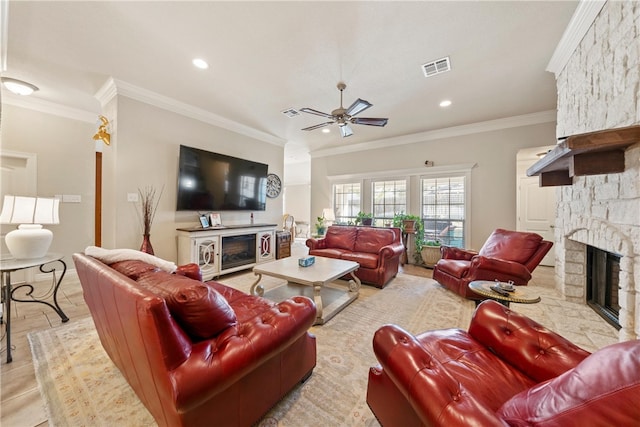 living room featuring visible vents, ornamental molding, a fireplace, and ceiling fan