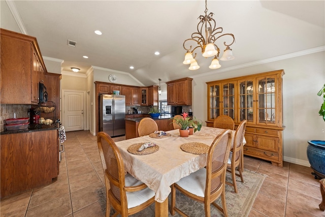 dining area with light tile patterned floors, lofted ceiling, a chandelier, and visible vents
