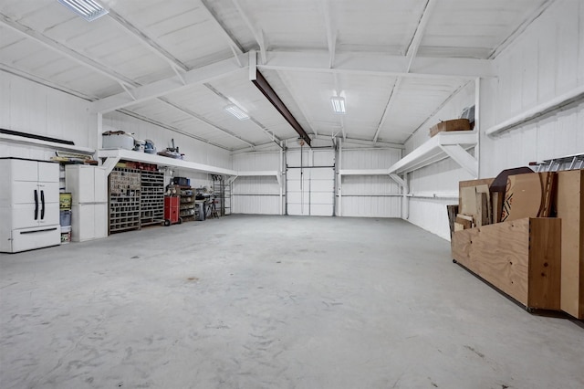 1210 Gordonville Rd, Gordonville, TX 76245 - garage with white refrigerator and metal wall